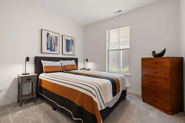 a bedroom with a bed and cabinet