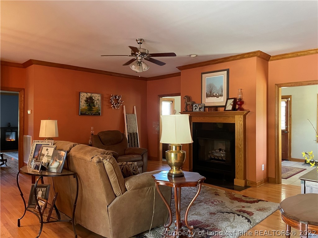 127 Doane Ranch Road Raeford, NC 28376 - Photo 12 of 47 a living room with furniture a fireplace and a flat screen tv