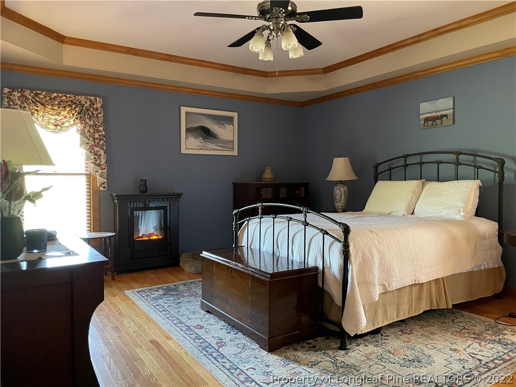 127 Doane Ranch Road Raeford, NC 28376 - Photo 26 of 47 a bedroom with a bed and wooden floor