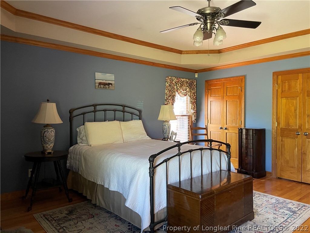 127 Doane Ranch Road Raeford, NC 28376 - Photo 27 of 47 a bedroom with a bed and wooden floor