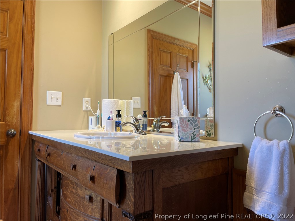 127 Doane Ranch Road Raeford, NC 28376 - Photo 30 of 47 a bathroom with a sink vanity granite and a mirror