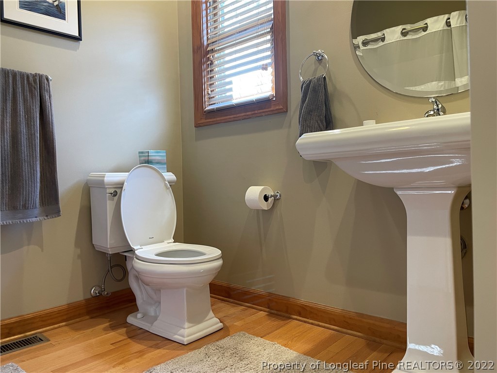 127 Doane Ranch Road Raeford, NC 28376 - Photo 34 of 47 a bathroom with a toilet sink and mirror