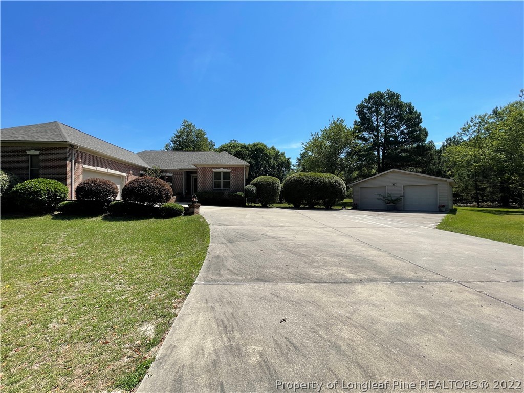 127 Doane Ranch Road Raeford, NC 28376 - Photo 6 of 47 a street view with a garden
