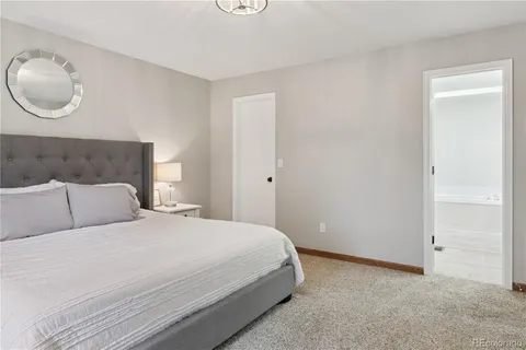 a bedroom with a bed and cabinets