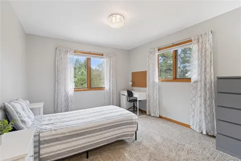 a bedroom with a bed and a tv on the dresser