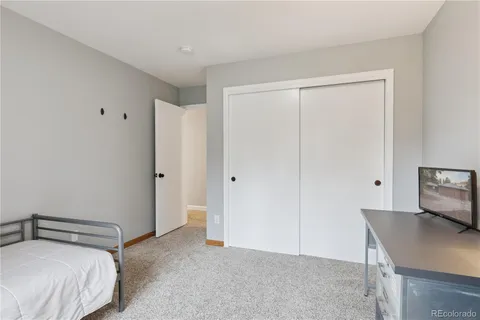 a bedroom with a bed and a table in it