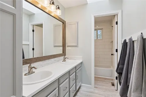 a bathroom with a double vanity sink and a mirror