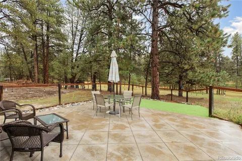 a view of a park with bench and trees