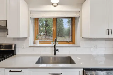 a kitchen with a sink and large window