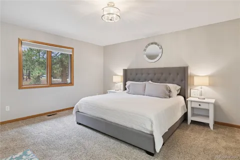 a bedroom with bed and a window