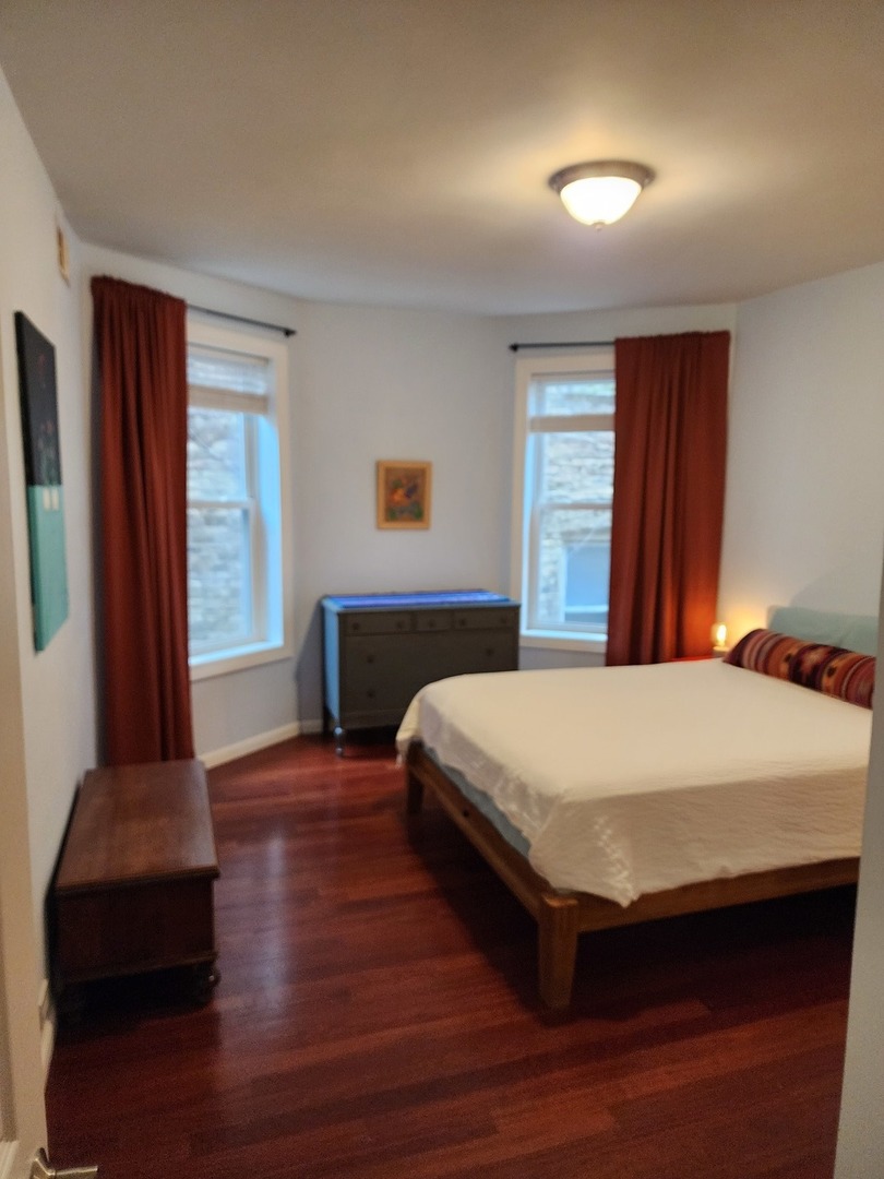 900 West Margate Terrace, Unit 2A Chicago, IL 60640 - Photo 11 of 21 a bedroom with a bed and a window