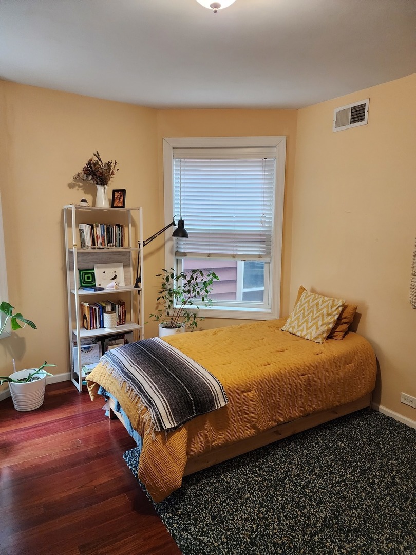 900 West Margate Terrace, Unit 2A Chicago, IL 60640 - Photo 16 of 21 a bedroom with bed and window