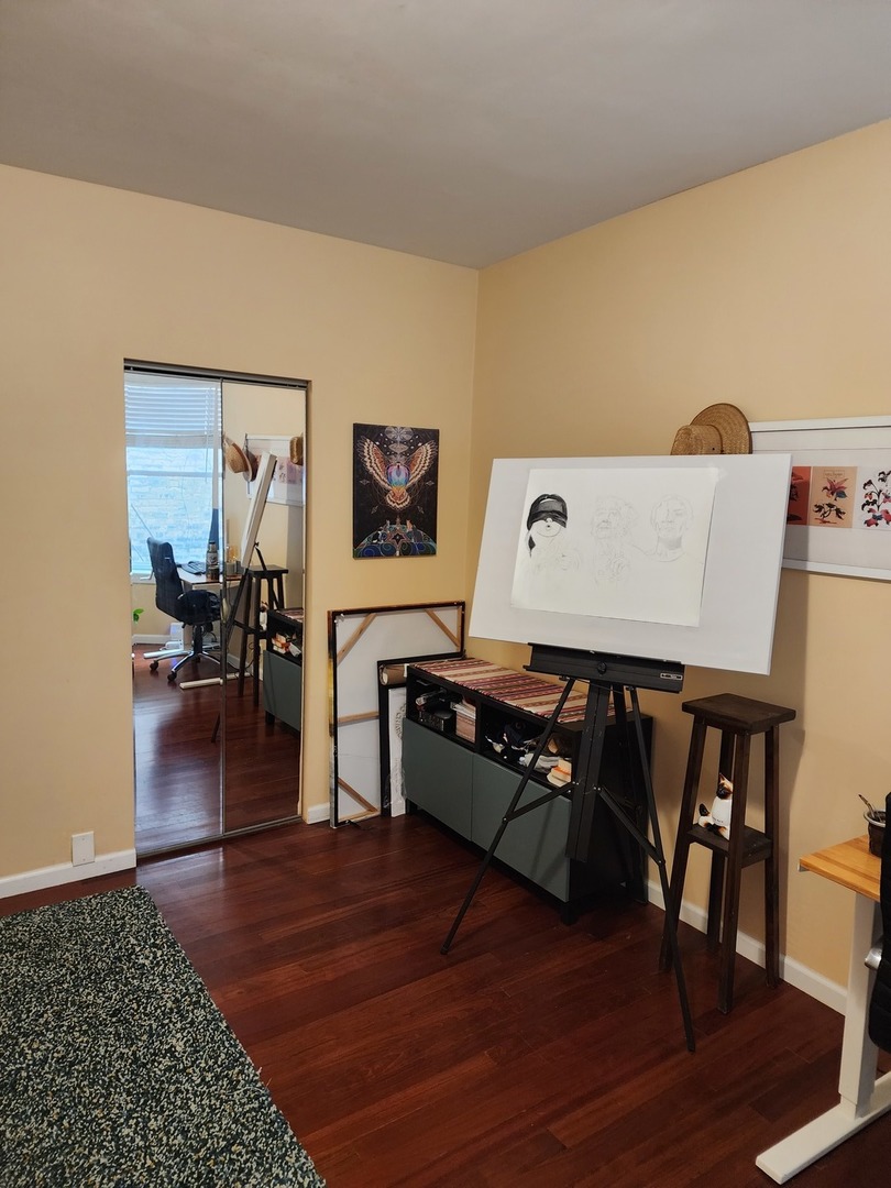 900 West Margate Terrace, Unit 2A Chicago, IL 60640 - Photo 17 of 21 a living room with furniture and a flat screen tv