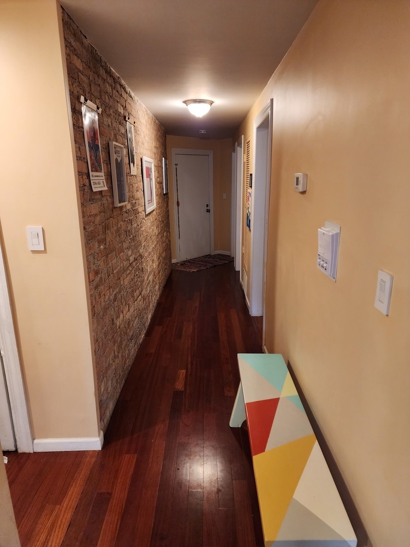 900 West Margate Terrace, Unit 2A Chicago, IL 60640 - Photo 10 of 21 a view of hallway with wooden floor
