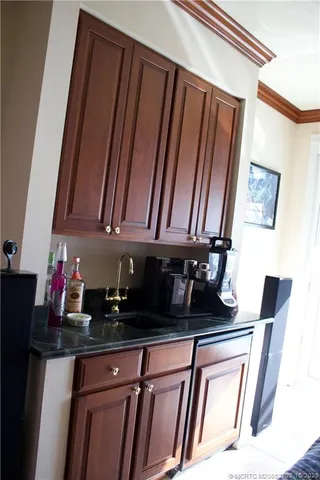 a kitchen with a sink a refrigerator and cabinets