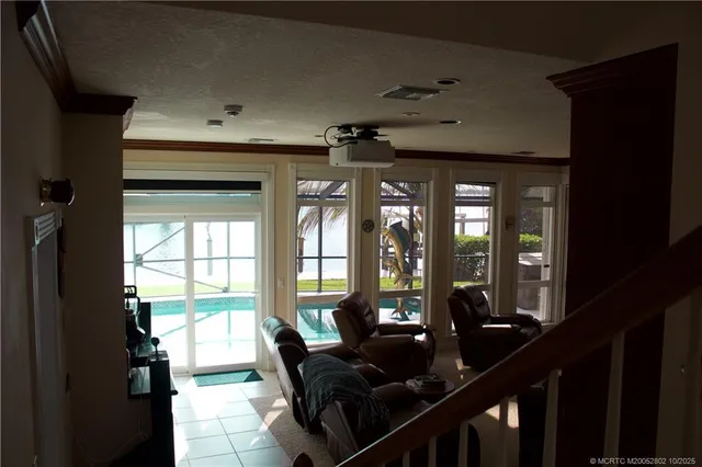 a living room with furniture and large windows