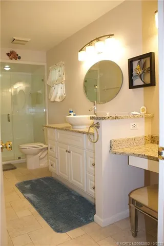 a bathroom with a sink a toilet and a mirror