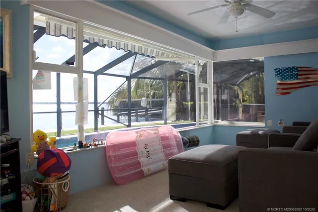 a bedroom with furniture and a large window