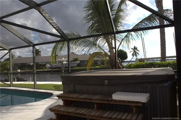 a living room with furniture a chandelier and a window