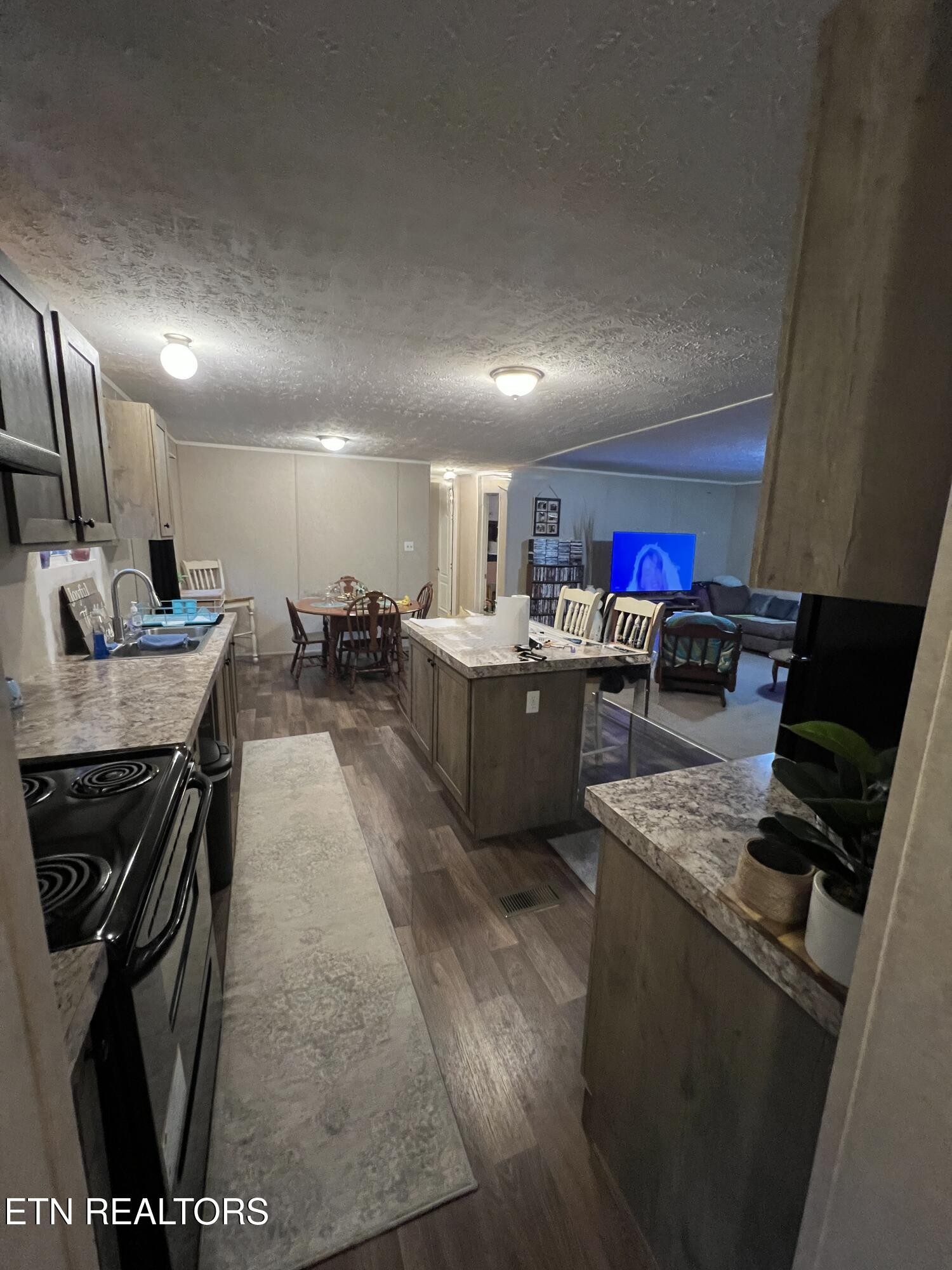 10207 Alex Bales Road Kodak, TN 37764 - Photo 5 of 18 a kitchen with stainless steel appliances kitchen island granite countertop a sink stove and cabinets