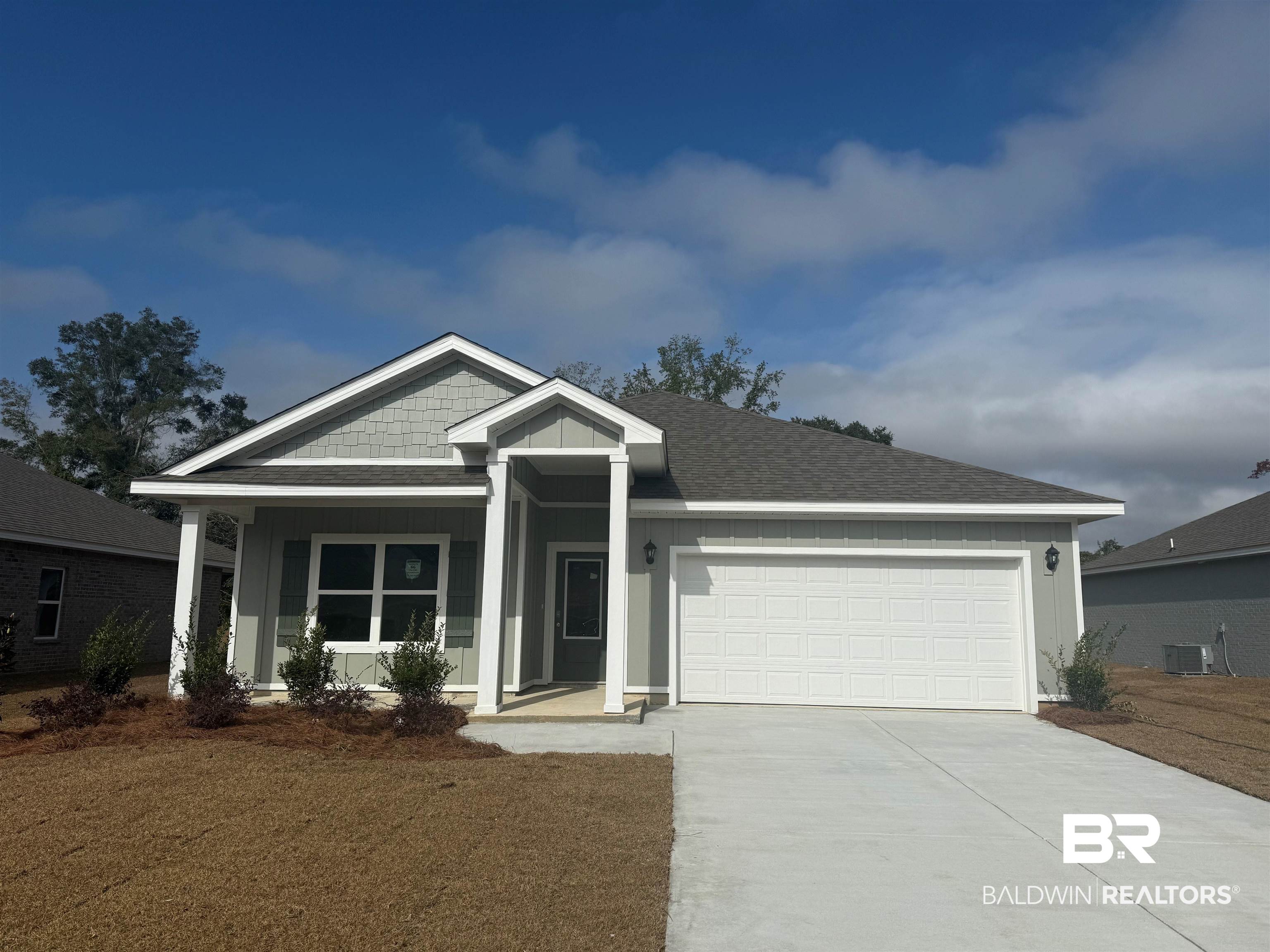 16192 Laurelbrooke Loop Fairhope, AL 36532 - Photo 1 of 43 View of front facade with central AC unit, a front yard, a garage, and covered porch