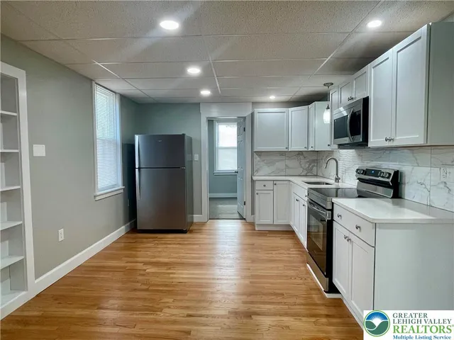 a kitchen with stainless steel appliances granite countertop a refrigerator sink and cabinets