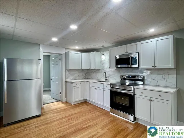a kitchen with a refrigerator stove and microwave