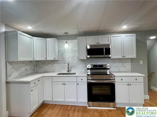 a kitchen with granite countertop a stove and a sink