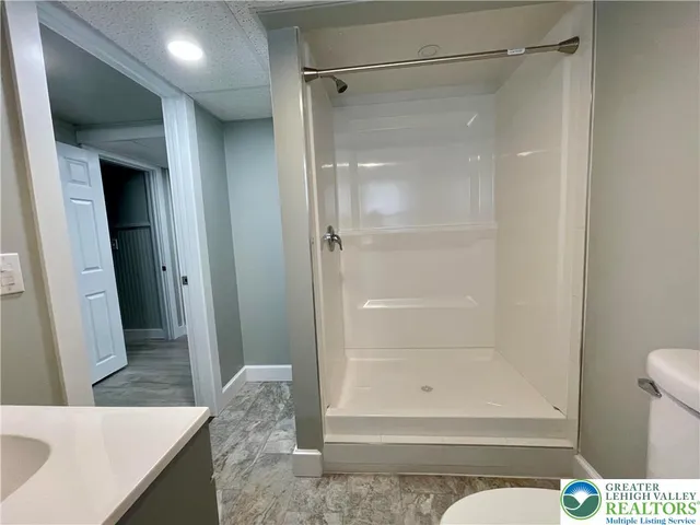 a bathroom with a shower and a sink