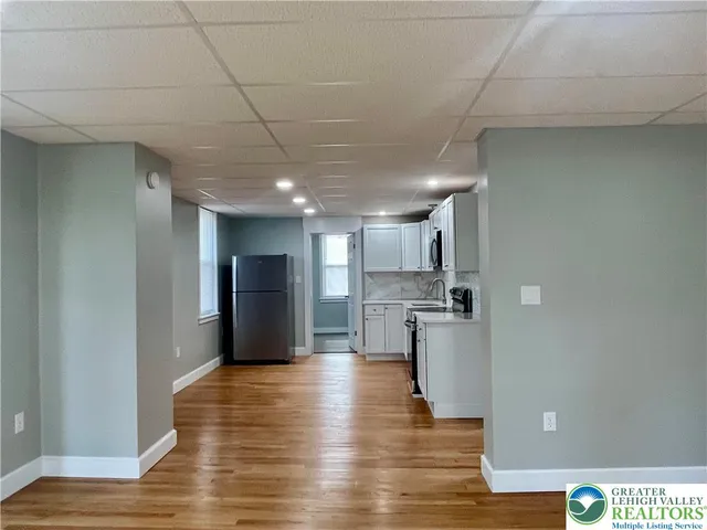 a view of a kitchen with a sink and stainless steel appliances