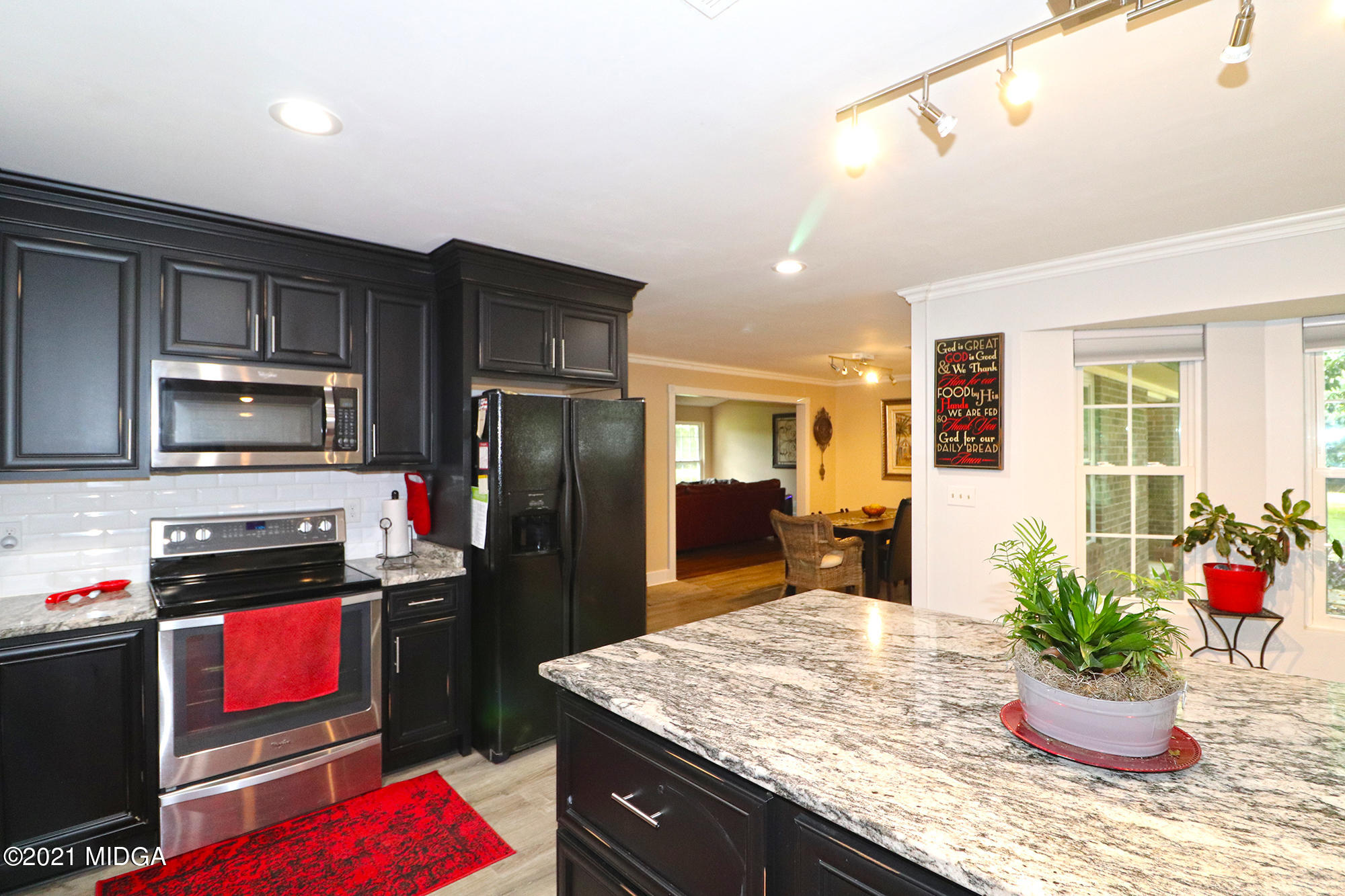 1571 Walker Road Byron, GA 31008 - Photo 3 of 60 a kitchen with stainless steel appliances kitchen island granite countertop a refrigerator a stove and a sink