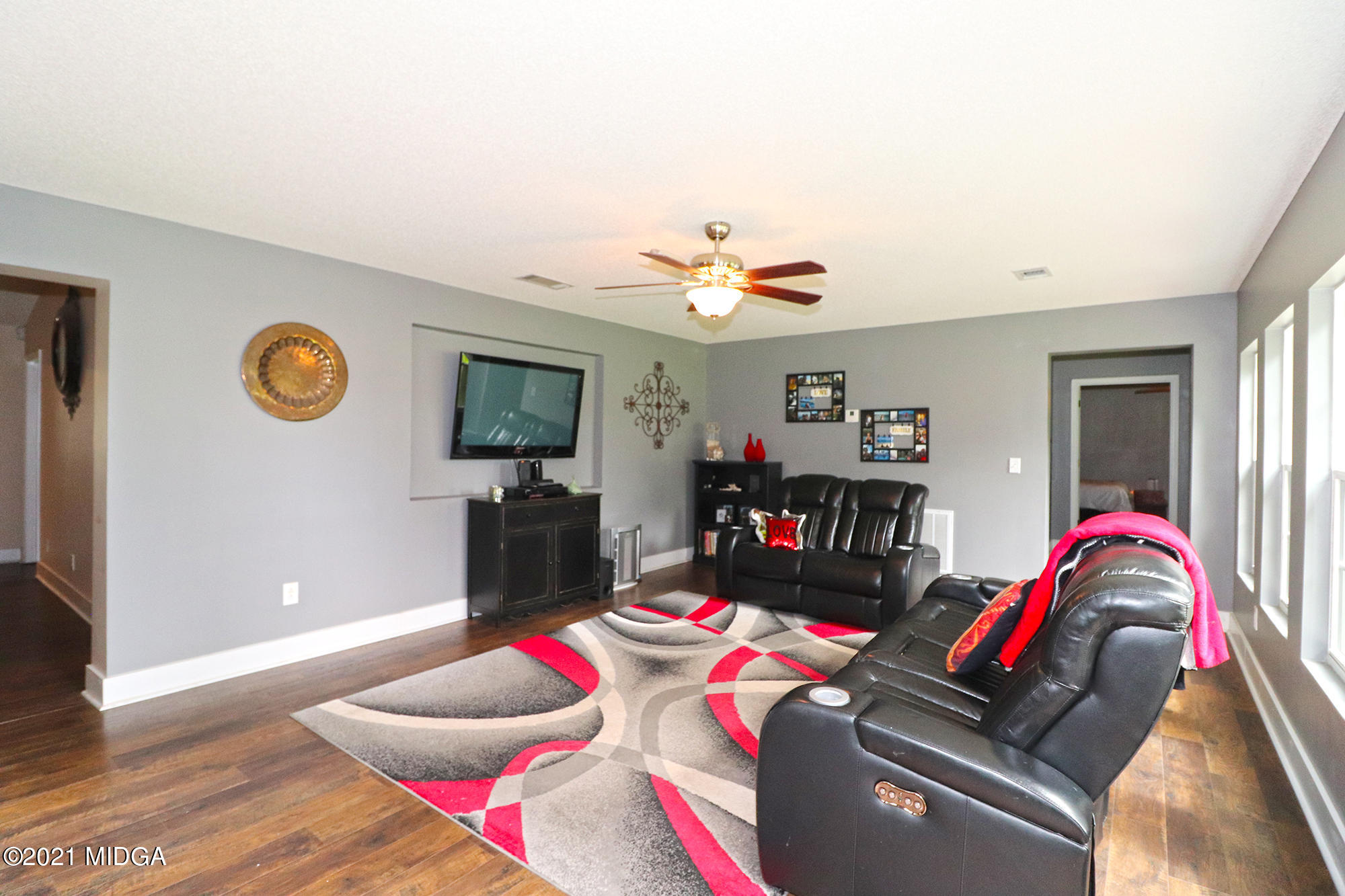 1571 Walker Road Byron, GA 31008 - Photo 21 of 60 a living room with furniture and a flat screen tv