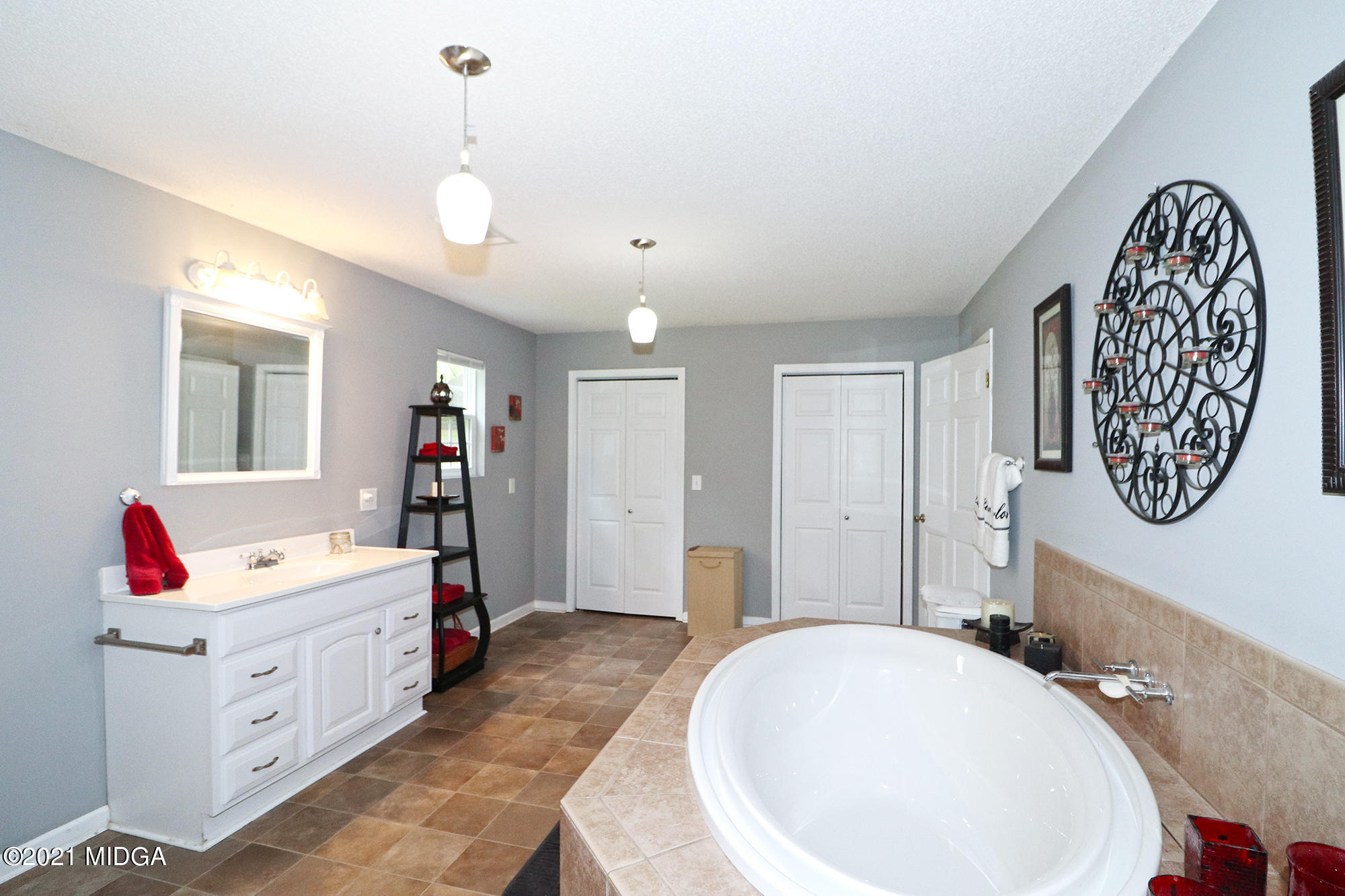1571 Walker Road Byron, GA 31008 - Photo 26 of 60 a spacious bathroom with a tub sink and mirror