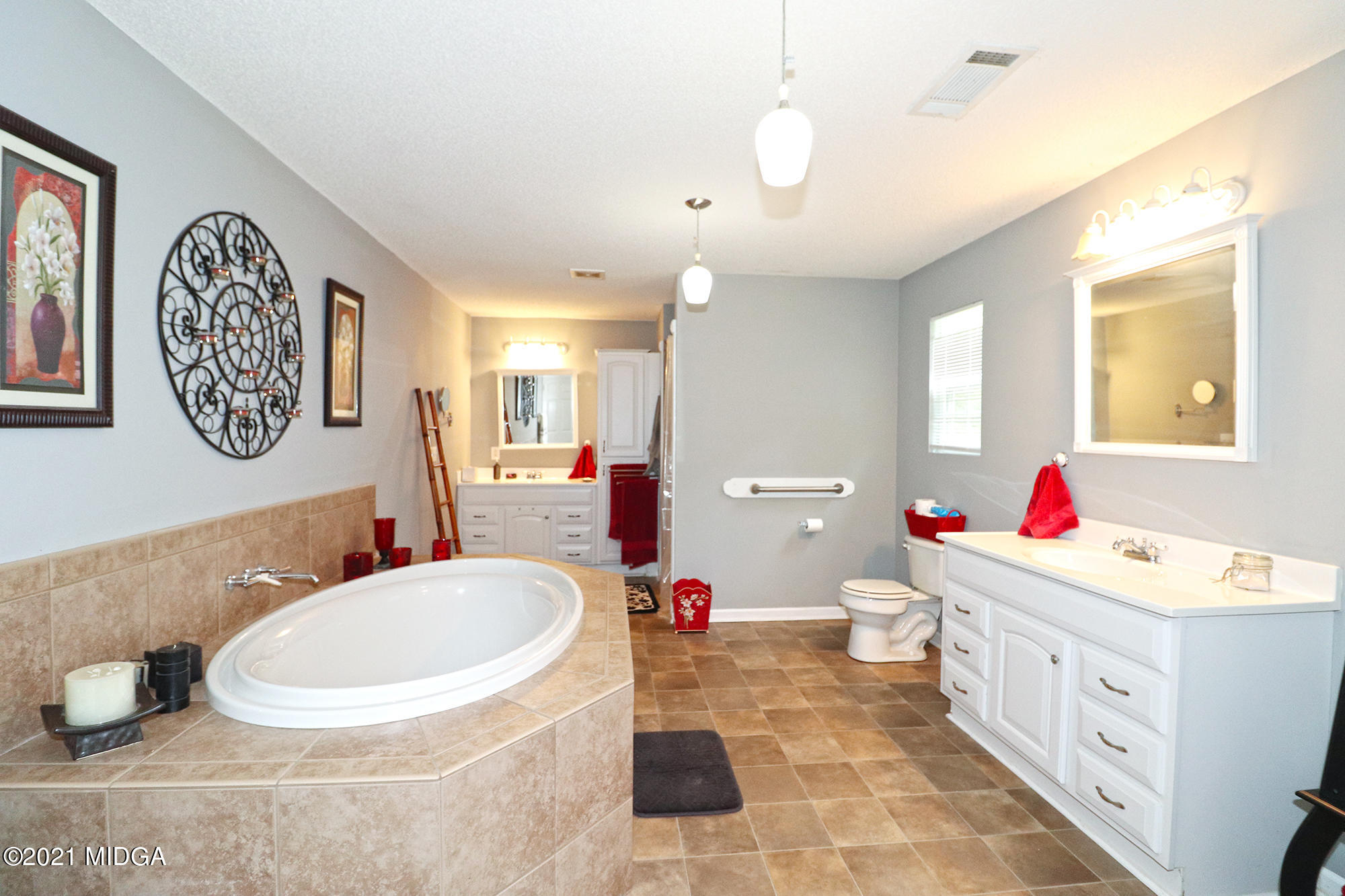 1571 Walker Road Byron, GA 31008 - Photo 27 of 60 a bathroom with a tub sink mirror and vanity