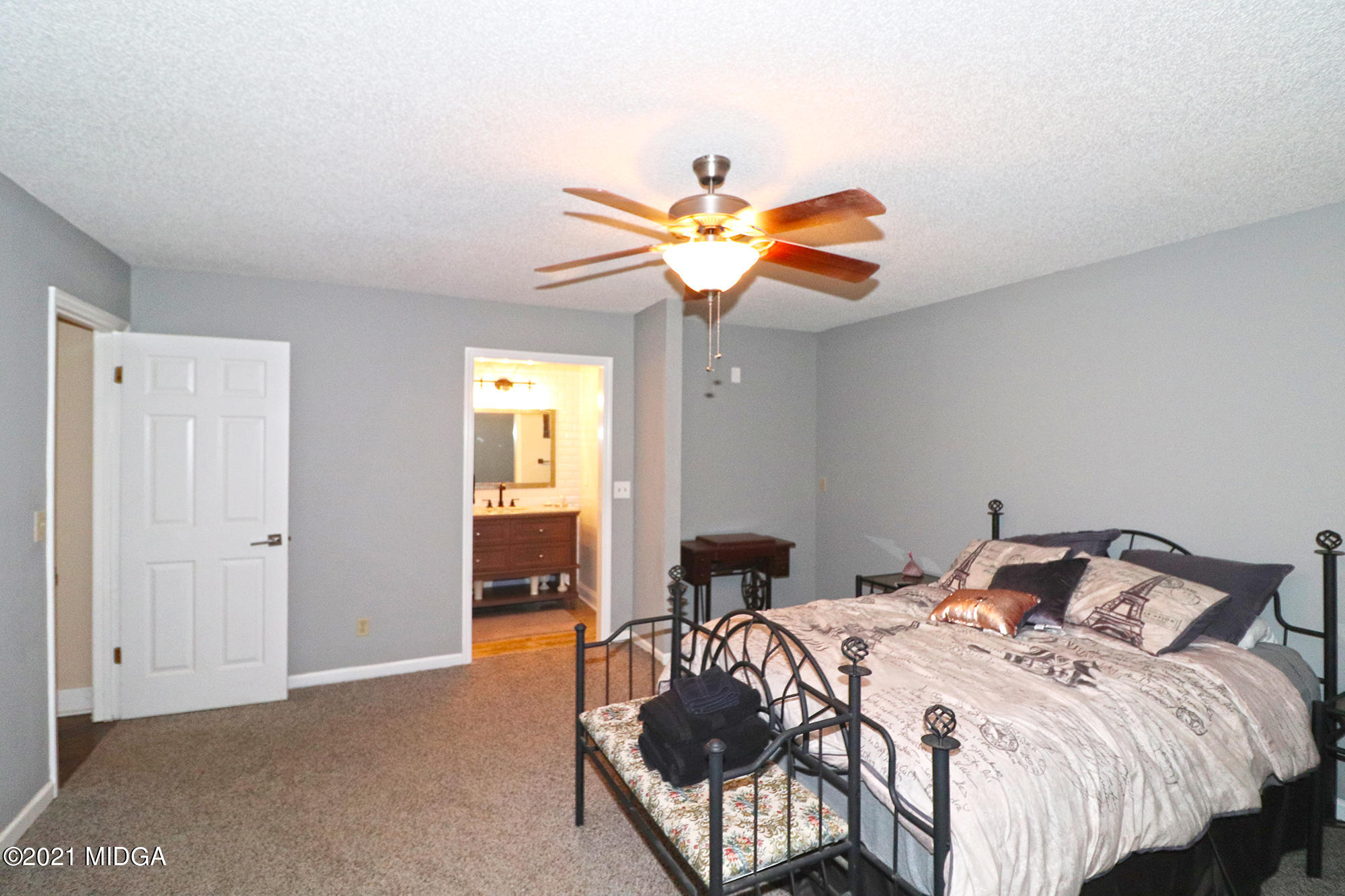 1571 Walker Road Byron, GA 31008 - Photo 32 of 60 a bedroom with a bed and a chandelier