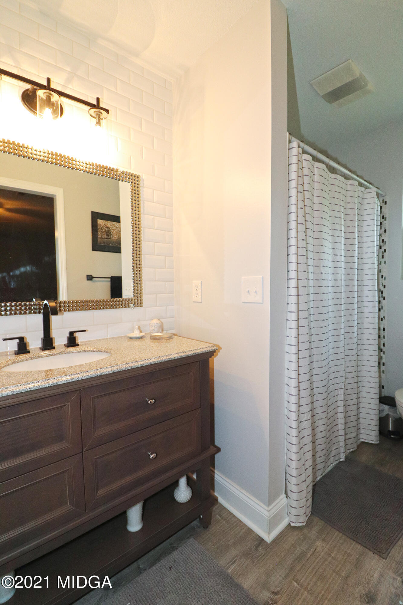 1571 Walker Road Byron, GA 31008 - Photo 34 of 60 a bathroom with a double vanity sink and mirror