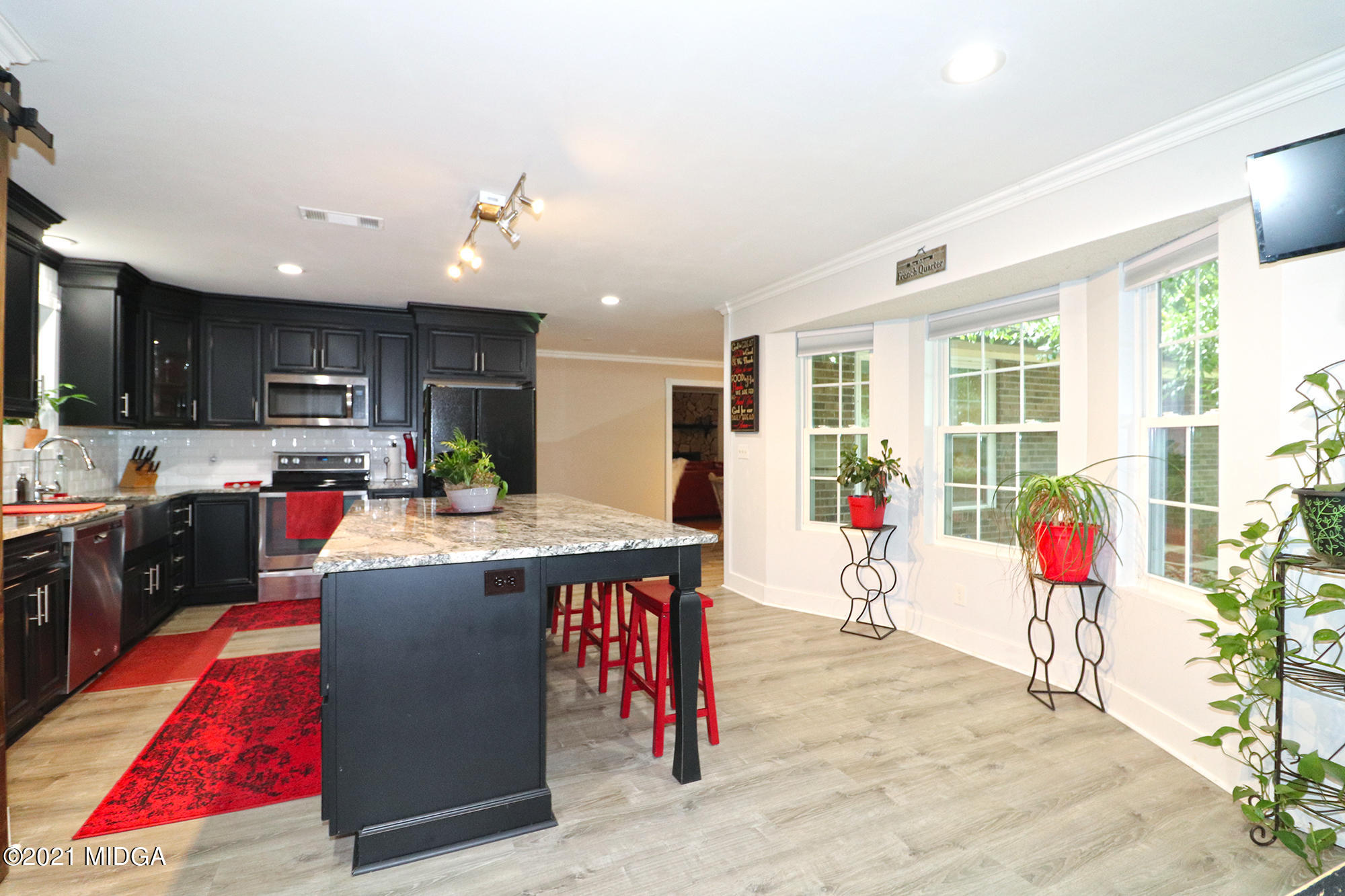 1571 Walker Road Byron, GA 31008 - Photo 5 of 60 a living room with kitchen island furniture and a wooden floor