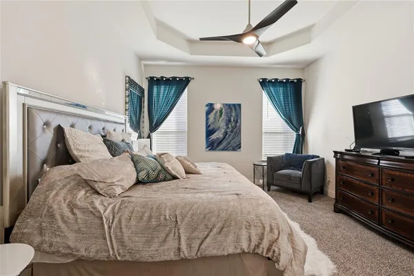 a bedroom with a bed a couch and dresser