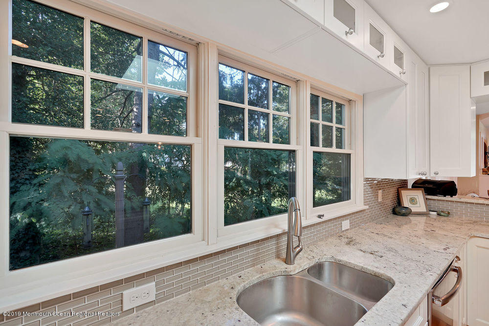907 Brooks Road Point Pleasant, NJ 08742 - Photo 14 of 33 a kitchen with granite countertop a sink and a wooden floor