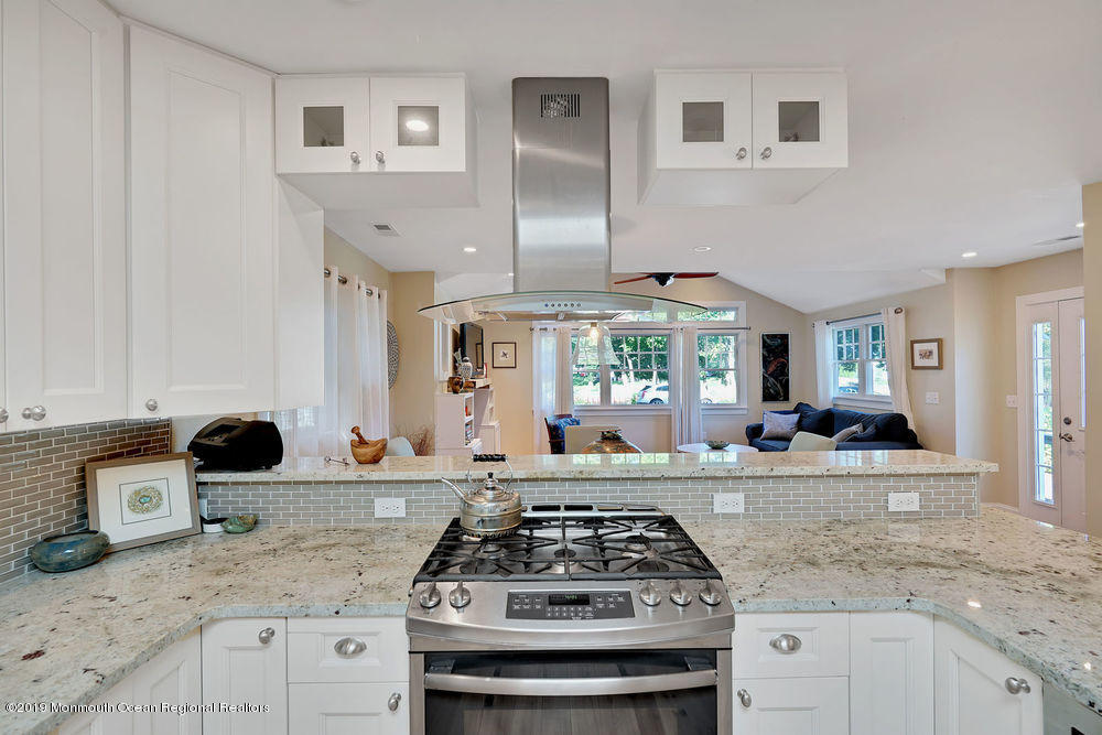 907 Brooks Road Point Pleasant, NJ 08742 - Photo 15 of 33 a kitchen with granite countertop stainless steel appliances a stove sink and cabinets
