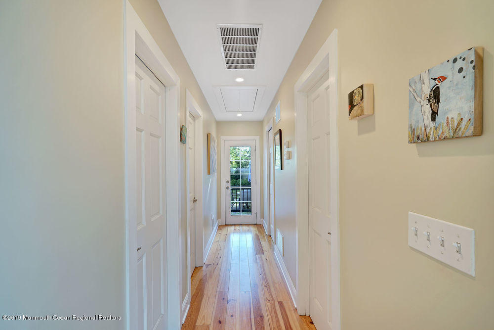 907 Brooks Road Point Pleasant, NJ 08742 - Photo 18 of 33 a view of a hallway with wooden floor and closet