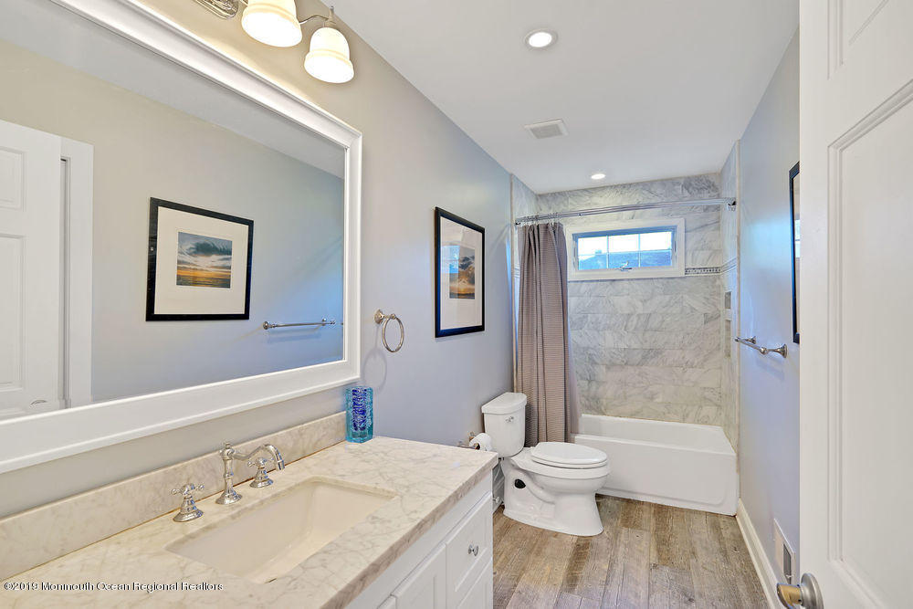 907 Brooks Road Point Pleasant, NJ 08742 - Photo 19 of 33 a bathroom with a granite countertop sink toilet and shower
