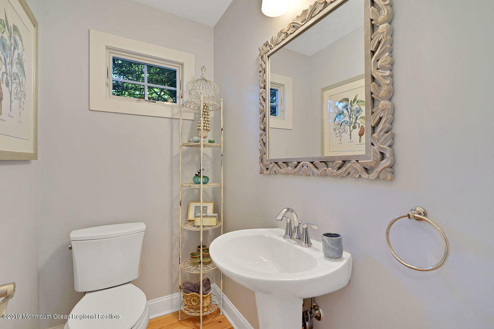 907 Brooks Road Point Pleasant, NJ 08742 - Photo 20 of 33 a bathroom with a toilet sink and mirror