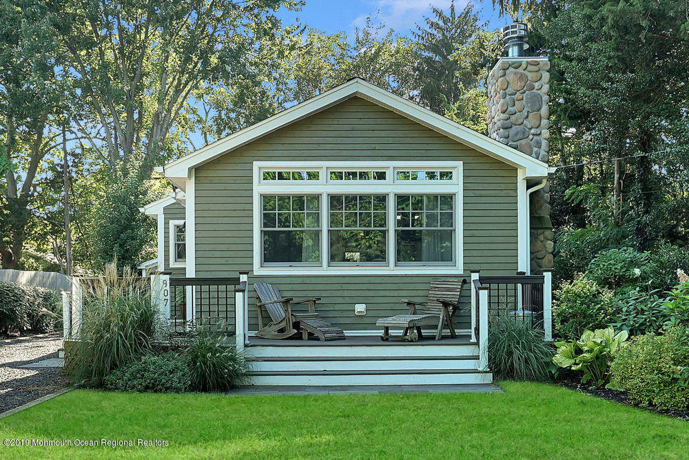 907 Brooks Road Point Pleasant, NJ 08742 - Photo 2 of 33 a front view of a house with a yard