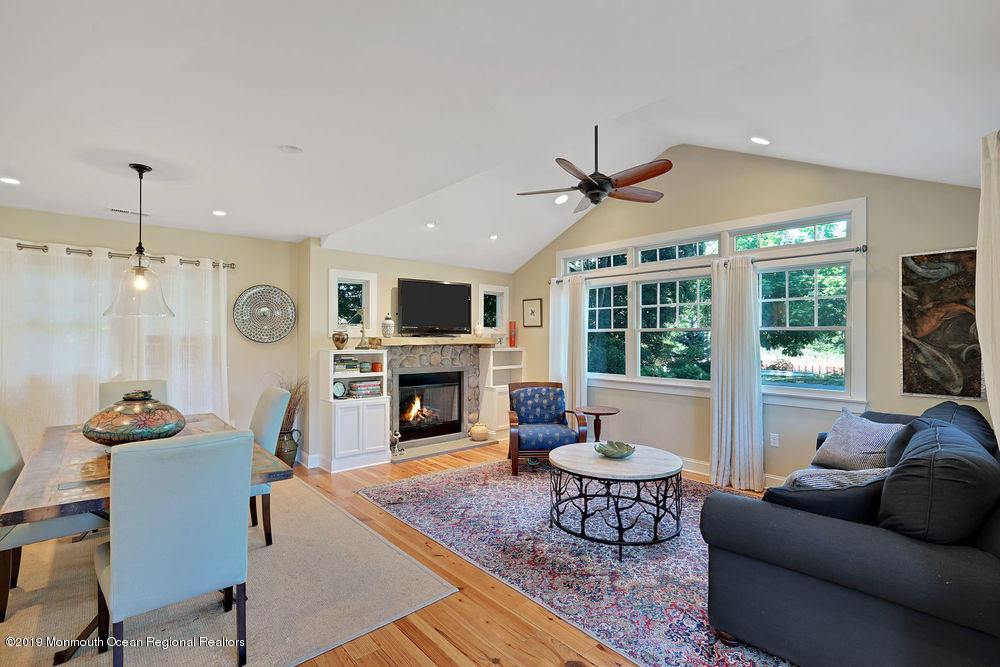 907 Brooks Road Point Pleasant, NJ 08742 - Photo 7 of 33 a living room with furniture a fireplace and a floor to ceiling window