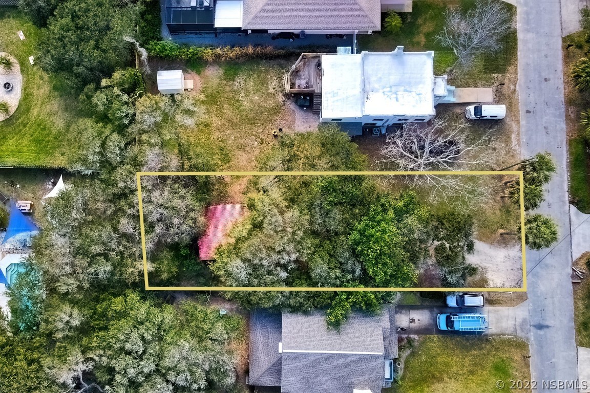 an aerial view of a house with a yard basket ball court