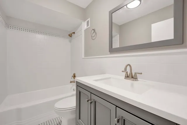 a bathroom with a sink a toilet and a bathtub