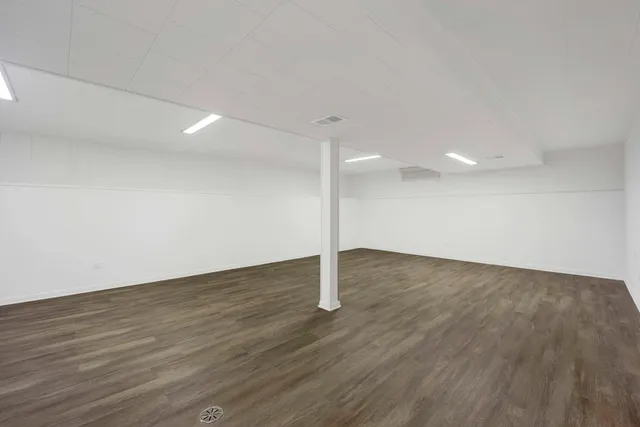 a view of a room with wooden floor and window