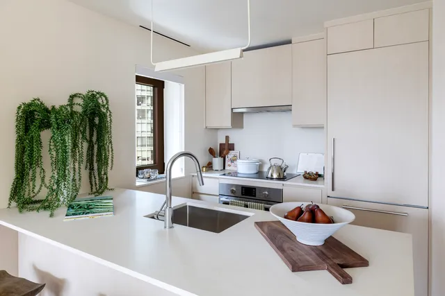 a open kitchen with stainless steel appliances granite countertop a lot of counter space and wooden floors