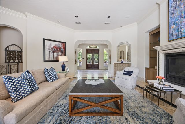 a living room with furniture a rug and a fireplace